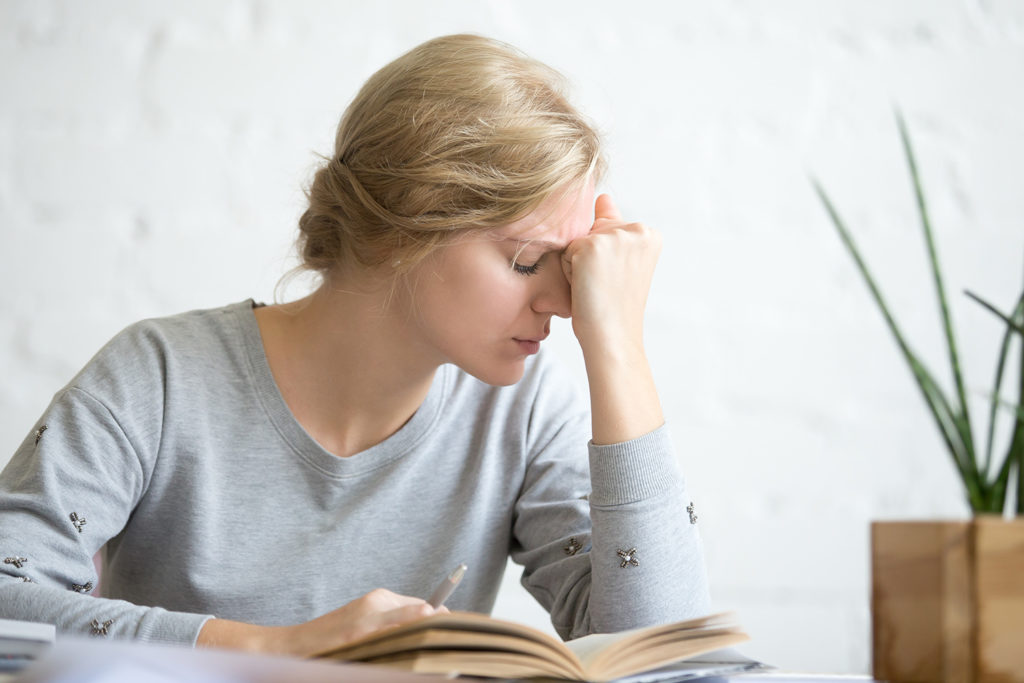 woman suffering from vertigo after reading